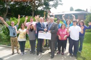 Picture shows President Mike Barton (left) presenting the cheque to 

Craig Ribbens of St. Mary’s surrounded by the students who took part in the torch relay
